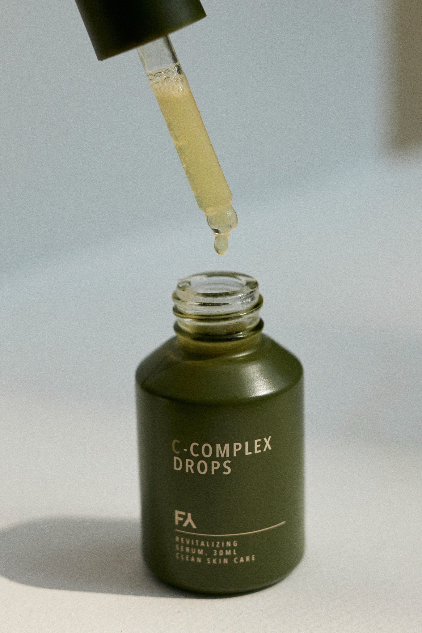 Image showing the natural skin serum C-Complex Drops in use