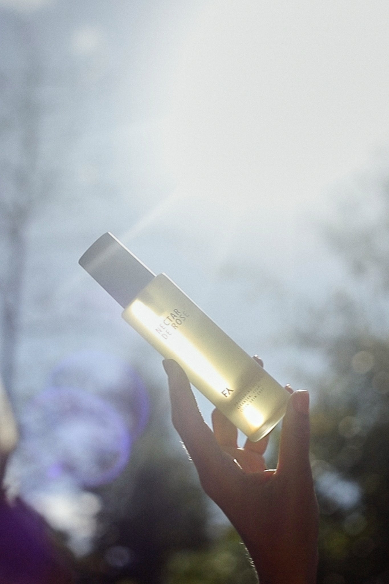 Campaign shot of the Nectar De Rose Nourishing Oil-to-Milk Cleanser counter light held next to the sunlight