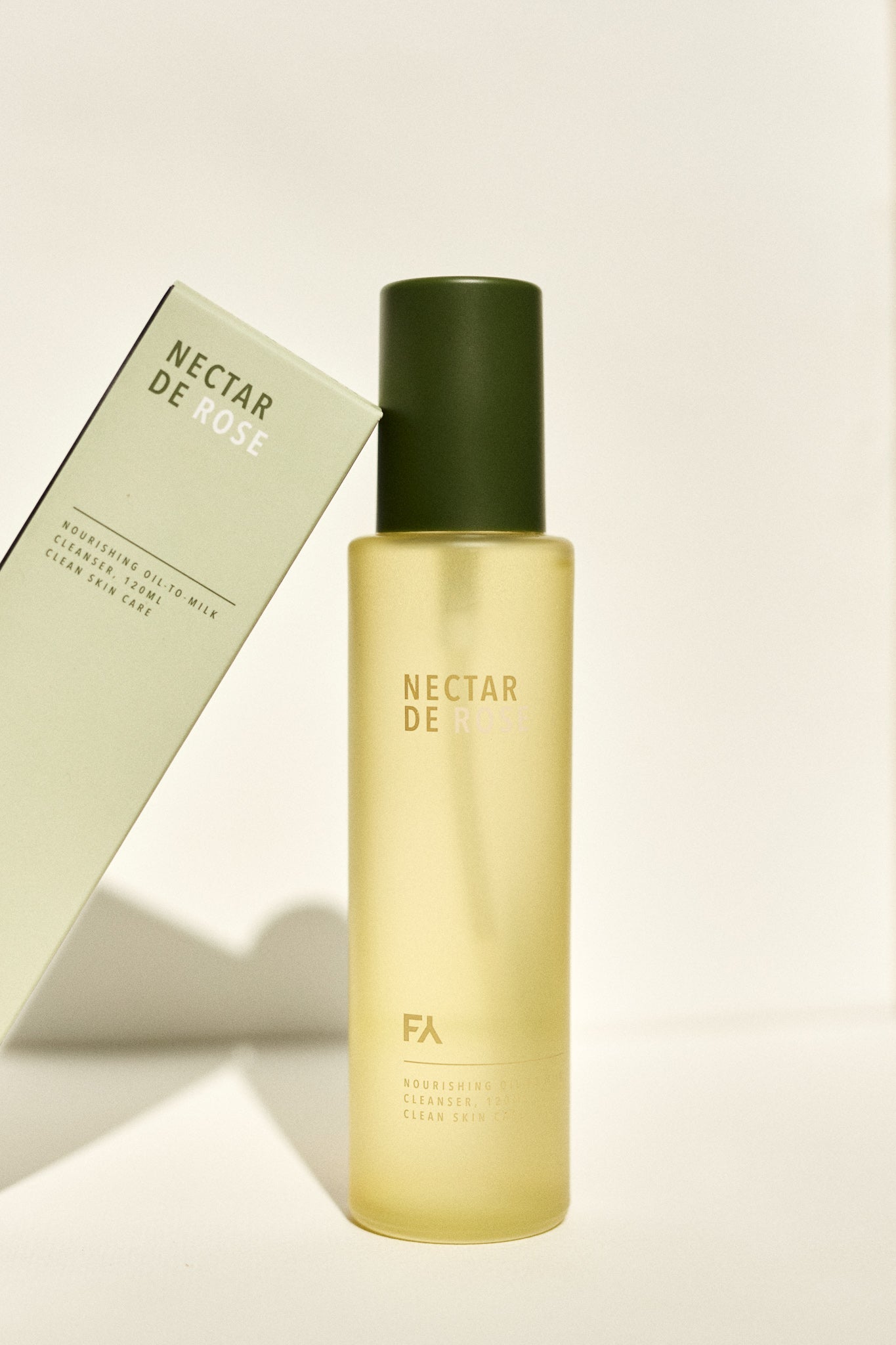 Campaign picture of the Nectar De Rose Nourishing Oil-to-Milk Cleanser next to its packaging