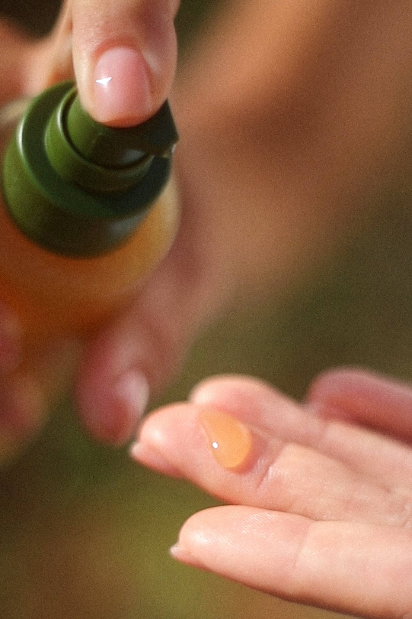 Campaign shot of the Fleur de Rose Soothing Cleanser by Fields of Yarrow being poured on a woman's fingertips