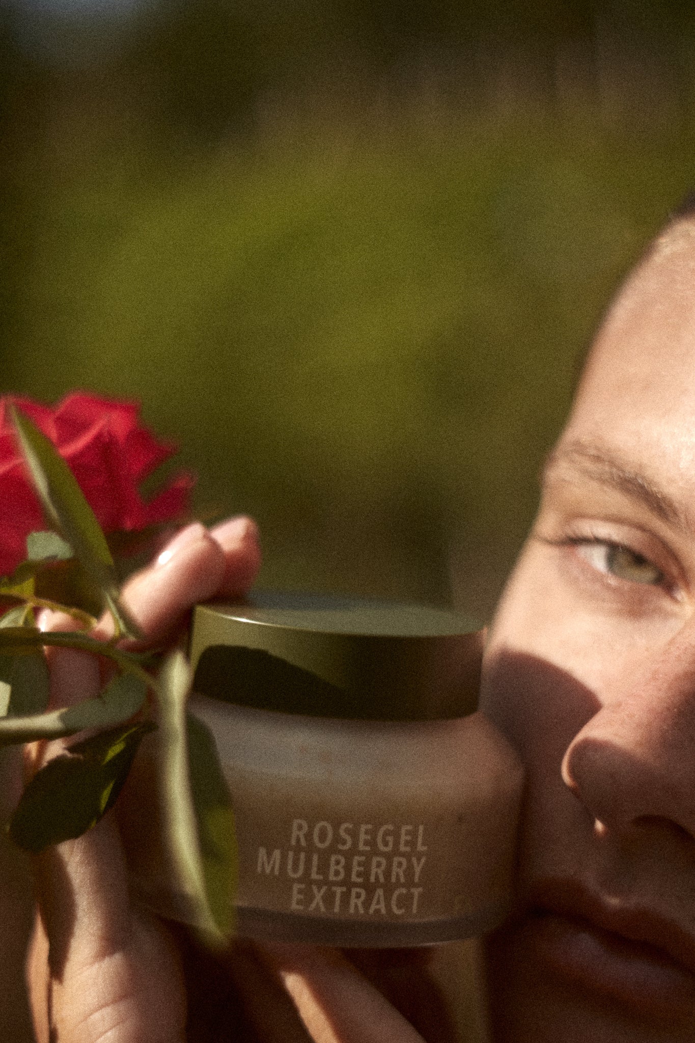 Picture of a model holding the Rosegle & Mulberry Extract hydrating face mask by Fields of Yarrow next to her face