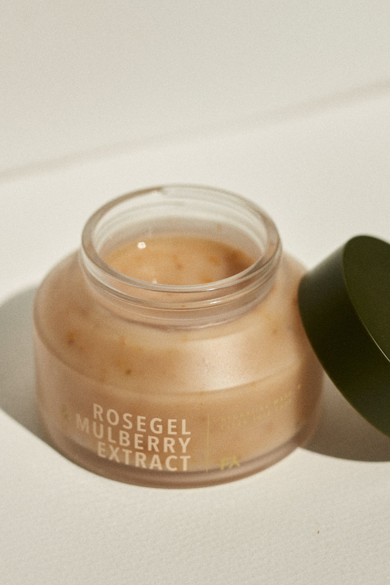 Still life photograph of the Rosegle & Mulberry Extract hydrating face mask by Fields of Yarrow jar with the lid open