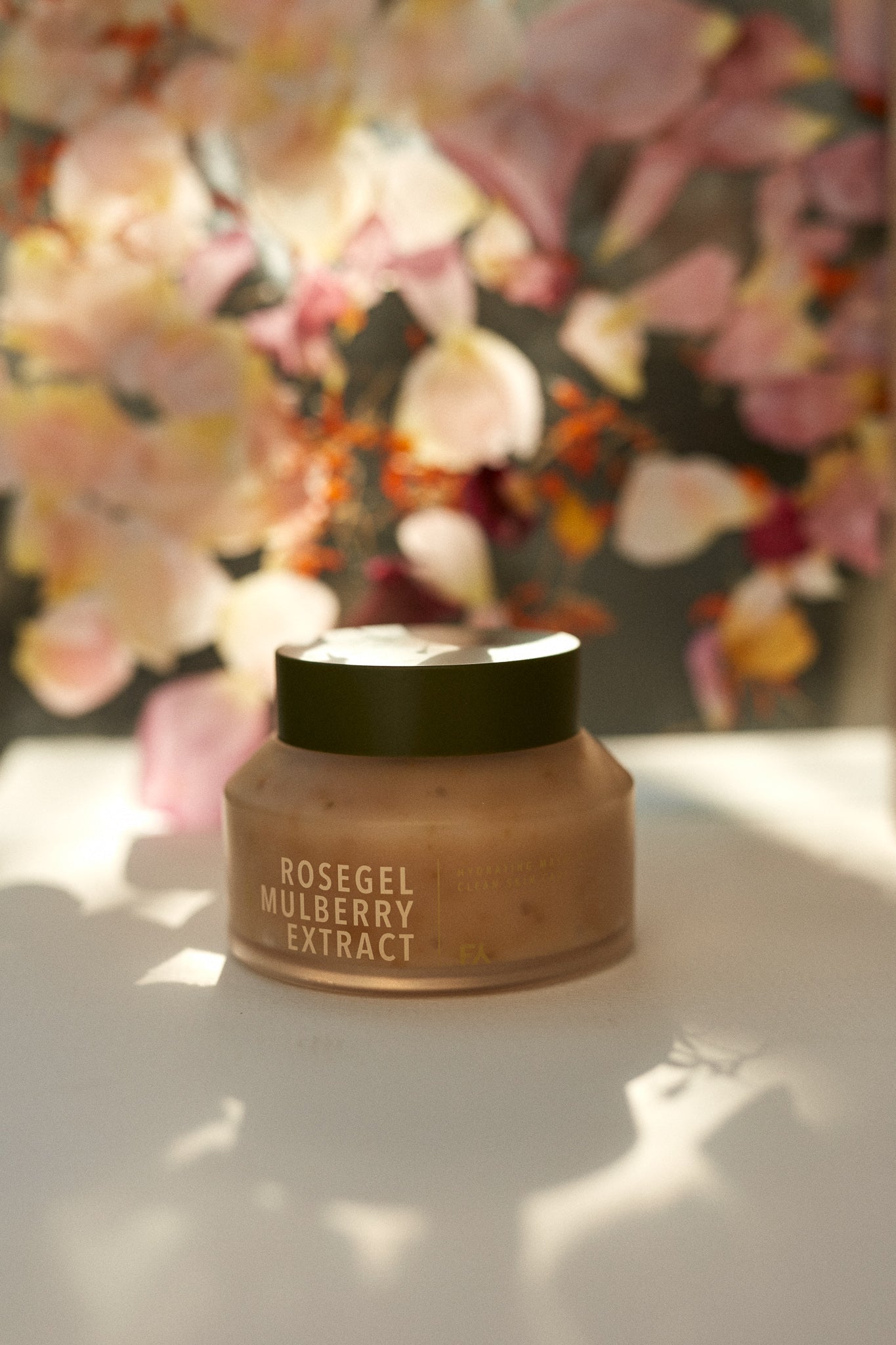 Campaign shot of the Rosegle & Mulberry Extract hydrating face mask by Fields of Yarrow with a flowers background