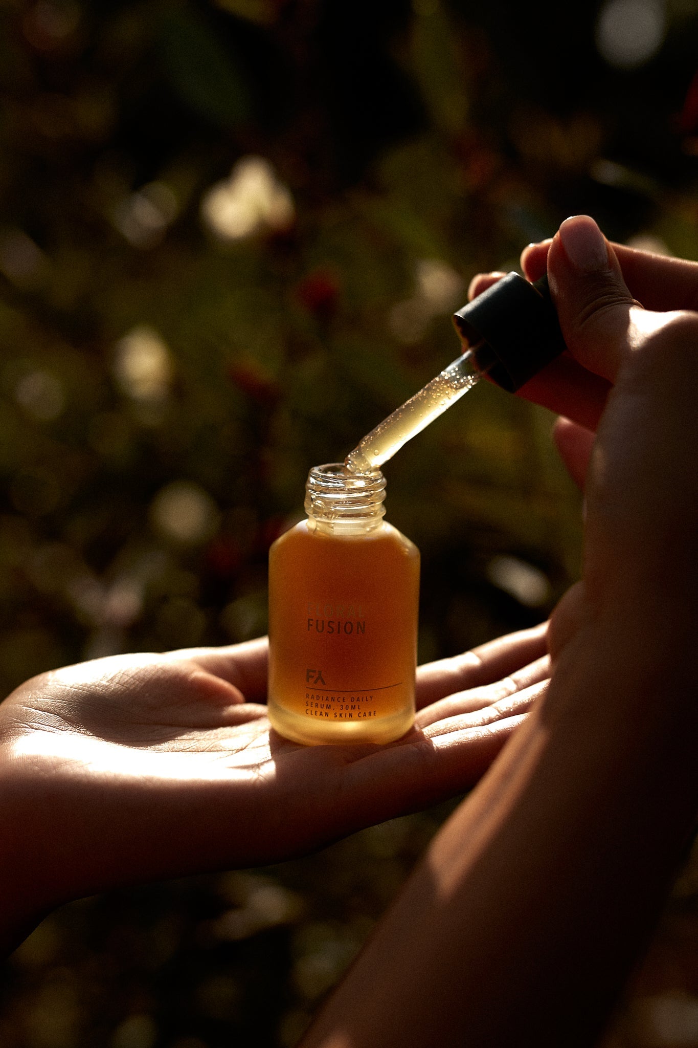 Campaign shot showing the Floral Fusion Radiance Daily Serum by Fields of Yarrow being used