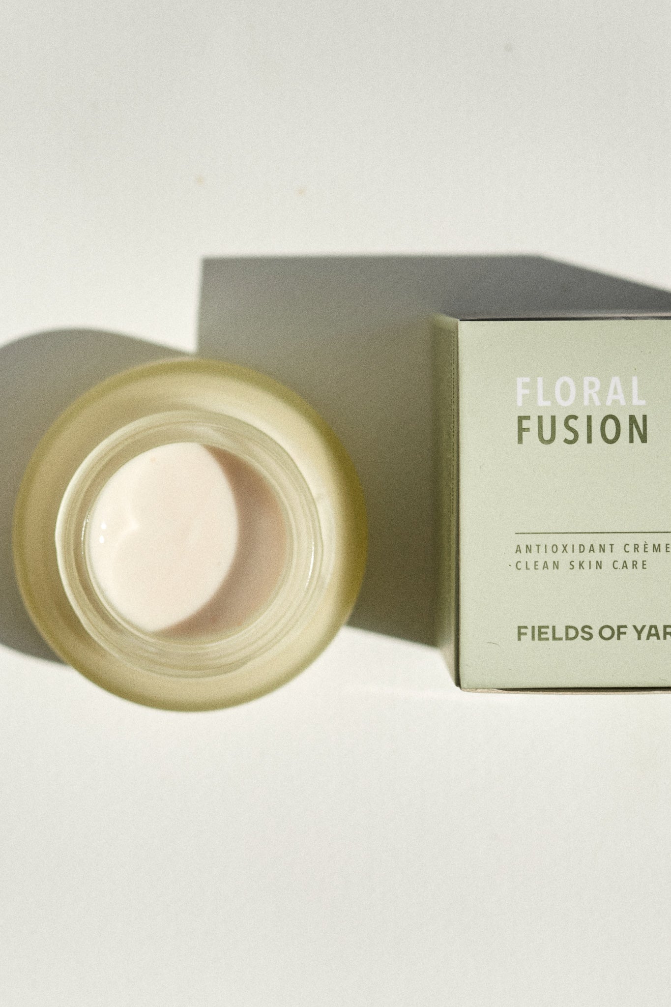 aerial view of the Floral Fusion Antioxidant Cream by Fields of Yarrow jar and packaging