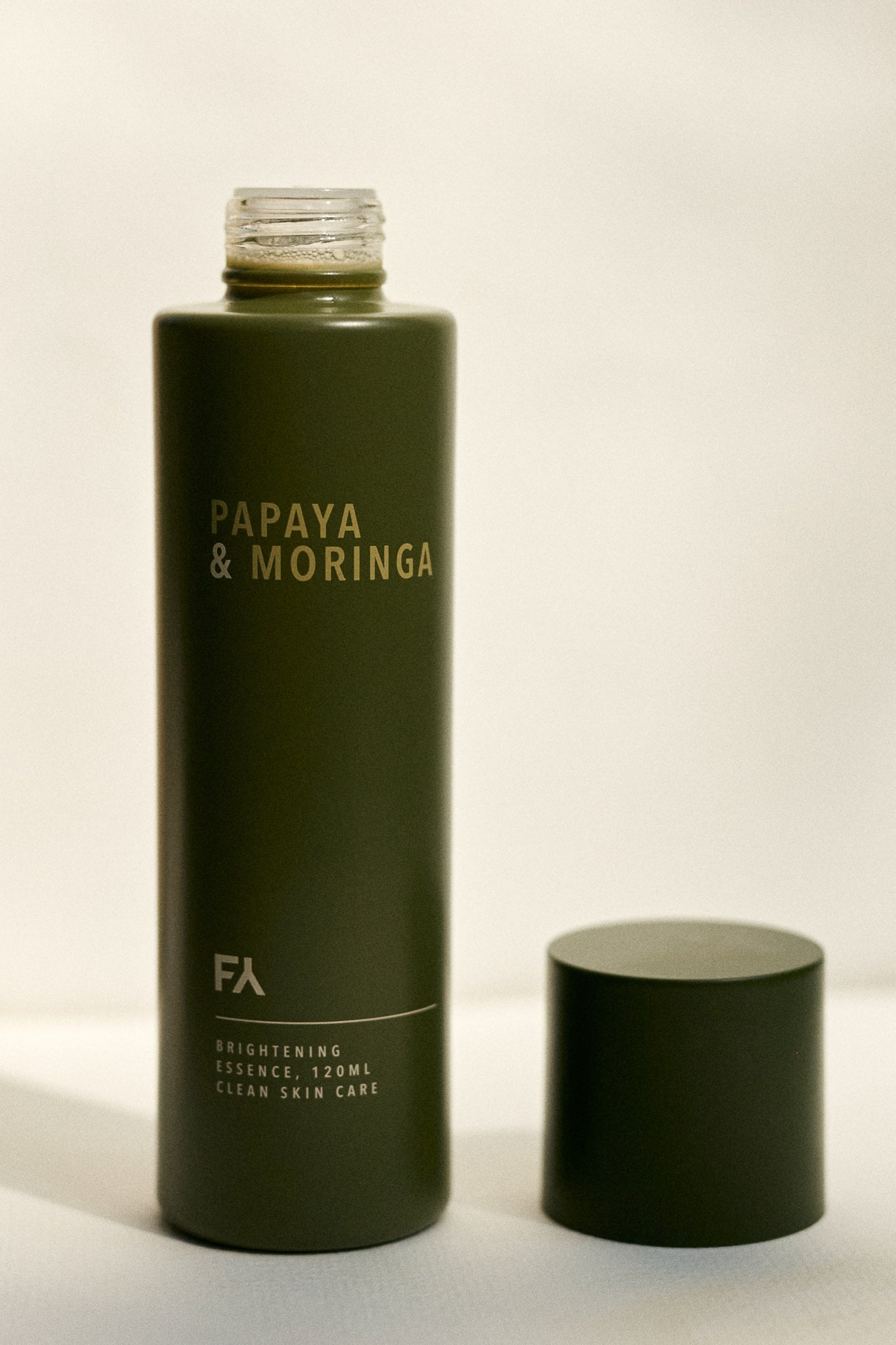 Campaign Shot showign the Papaya & Moringa Brightening Essence by Fields of Yarrow  with the opened lid