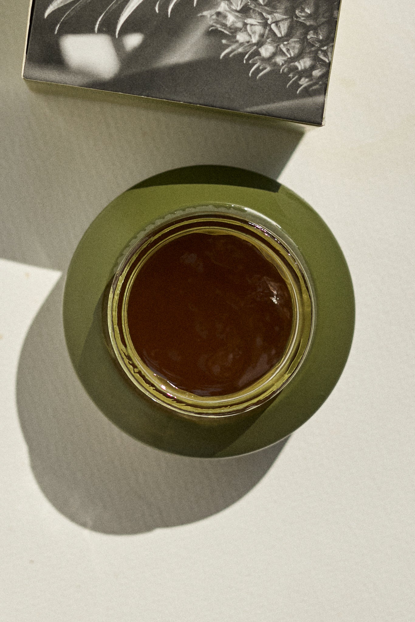 Aerial picture of the Papaya & Pineapple Enzymatic Cleanser by Fields of Yarrow jar with the lid open, showing the inside